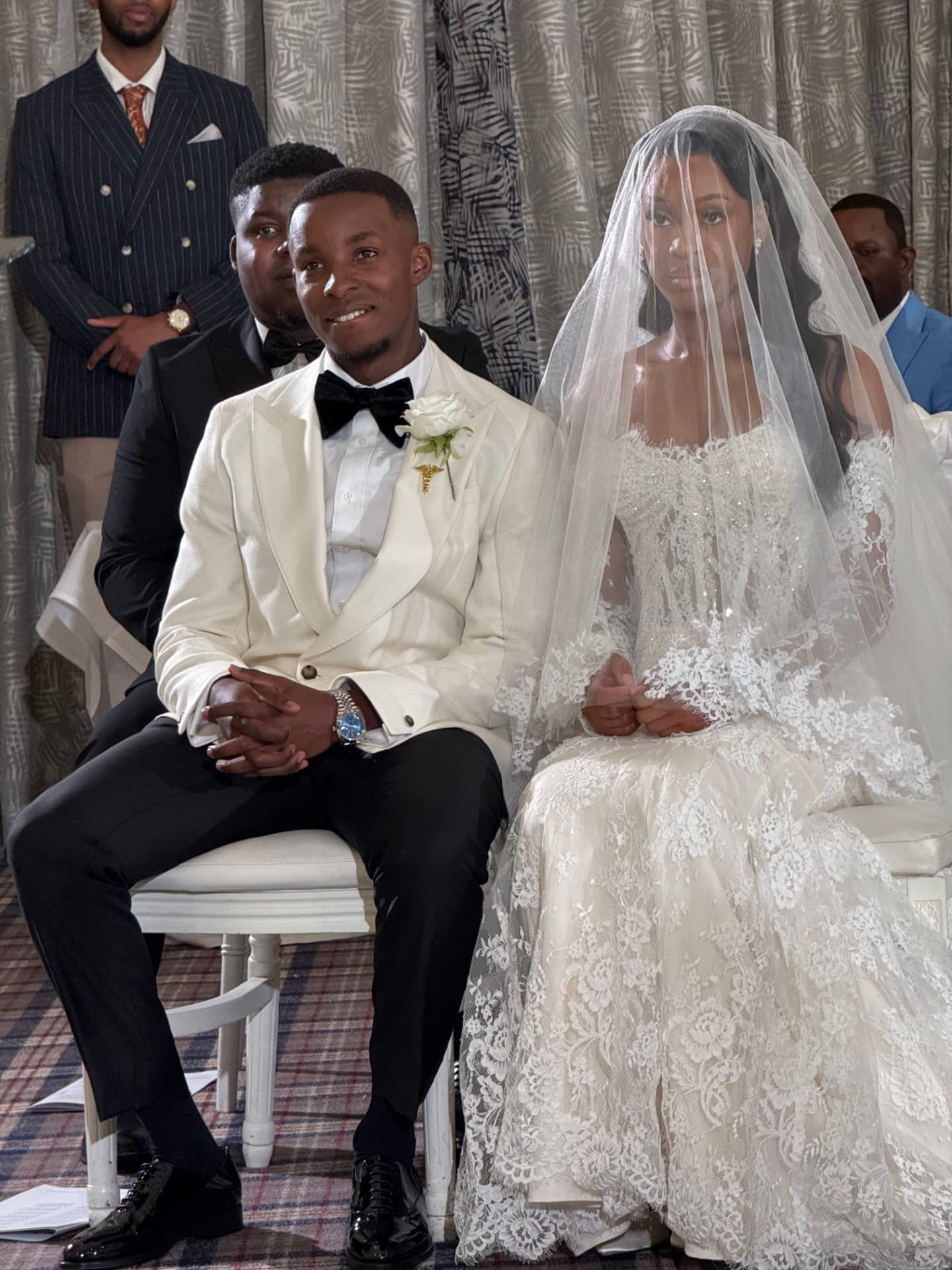 A bride and groom seated together during their wedding ceremony