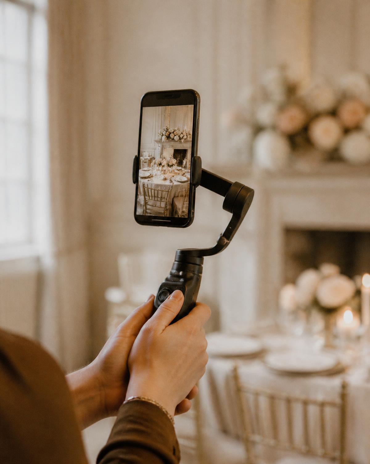 A phone on a gimbal filming vertical content at an elegant event